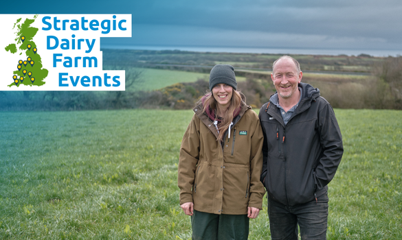 Farming couple smiling together in field.